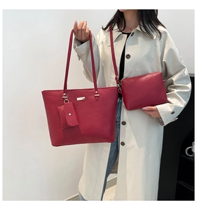 Vue détaillée d'un ensemble de sacs rouge foncé avec texture grainée et finitions dorées