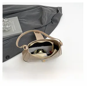 Internal view showing capacity of the beige sequin shoulder bag for phone and cosmetics