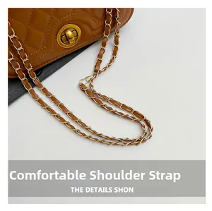 Close-up of caramel brown quilted leather bag featuring gold chain strap and metal lock