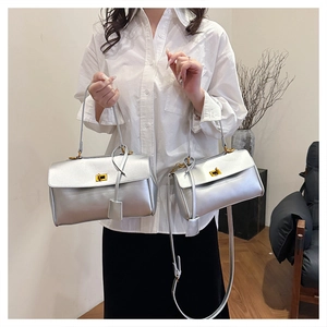 Detail view of silver tote bags in two sizes with gold turn-lock and metallic finish