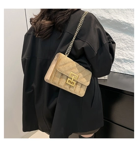 Détail du sac bandoulière en velours champagne doré avec texture matelassée et chaîne