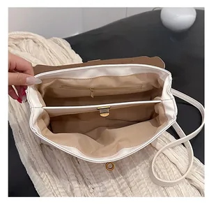 Detail view of the spacious dual-compartment interior and zipper pocket of this tote bag