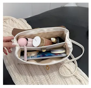Detailed interior view of a stylish leather tote with dual compartments and gold clasp