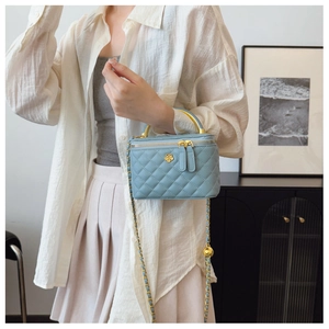 Fashionable light blue quilted box bag with gold floral logo and adjustable chain strap