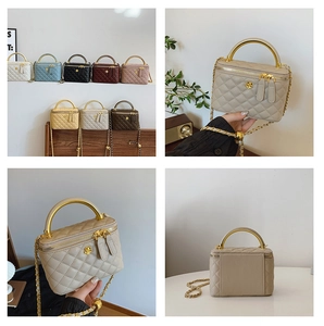 Detailed view of quilted mini vanity bag with gold handle and floral hardware detail