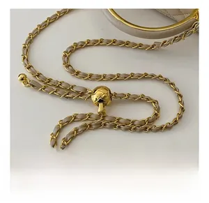 Detail of adjustable golden chain strap with diamond quilted metal ball on box bag