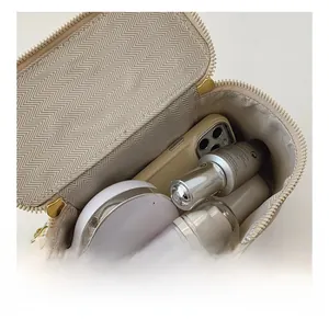 Close-up of beige quilted bag interior showing spacious storage for makeup and phone