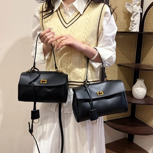Chic black leather tote bag with gold twist lock and shoulder strap in two sizes