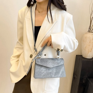 Grey marble texture envelope bag with rope handle shown on model in white suit
