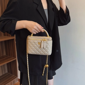 Beige quilted box bag with camellia metal logo and chain strap for crossbody wear