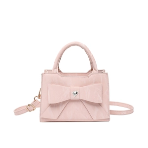 Elegant pink handbag with large bow and heart rhinestone, featuring crossbody strap