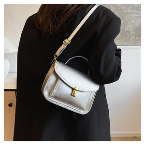 Silver mini square bag with metallic texture shown on a black blazer for chic styling
