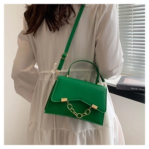 Fashionable green textured leather handbag with gold chain detail and wave edge flap