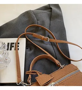 Detailed macro of brown woven texture handbag with adjustable strap and leather tag
