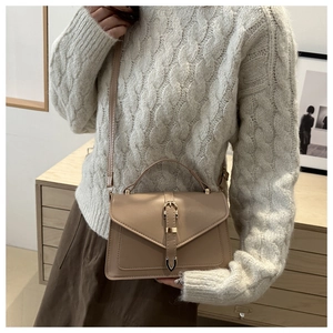 Chic beige crossbody square bag styled with an ivory cable knit sweater for autumn