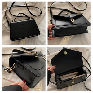 Macro detail of black leather crossbody bag with gold buckle and adjustable strap