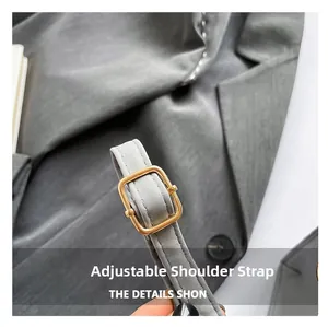 Detail shot of the gray adjustable synthetic leather shoulder strap with gold buckle