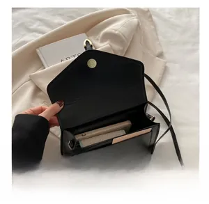 Interior view of black matte leather crossbody bag showing space for phone and wallet