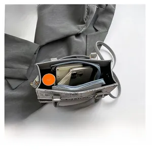 Interior view of grey tote bag showing large capacity for laptop and daily essentials
