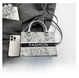 Detail view of grey patterned tote bag featuring a Fashion ribbon and fine stitching texture