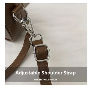 Detail showing adjustable dark brown synthetic leather strap with silver metal buckle
