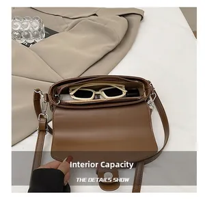 Detail view of the brown leather saddle bag interior capacity with sunglasses