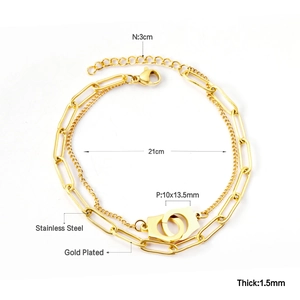 Detail of 18K gold-plated stainless steel double-layered chain bracelet with heart lock charm