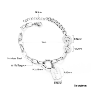 Detail of stainless steel double chain bracelet with smiley face and Good Luck pendant