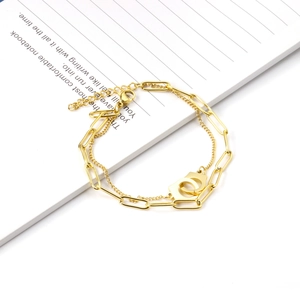 Detail of 18K gold stainless steel double chain with heart lock and paperclip link design