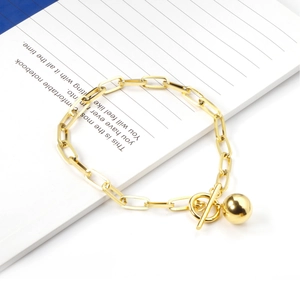 Detail of 18K gold stainless steel chain bracelet with OT toggle clasp and sphere pendant