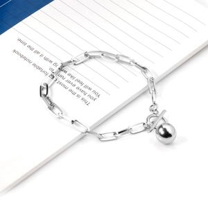 Close-up of silver paperclip link bracelet with OT buckle and solid round ball pendant