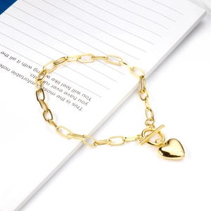 Detail of 18K gold stainless steel heart charm bracelet with classic toggle clasp