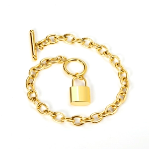 Detailed view of 18K gold plated thick chain bracelet with T-bar clasp and padlock pendant