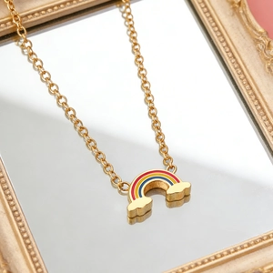 Golden rainbow necklace with colorful enamel pendant and cloud details in mirror reflection