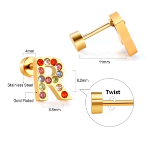 Macro detail of gold-plated stainless steel letter R earring with multi-colored crystals