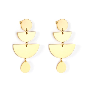 Close-up of golden multi-layer geometric earrings with polished finish and teardrop pendant