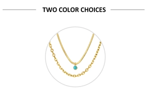 Detail of gold-plated layering necklace set with blue smiley face enamel charm