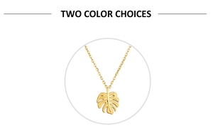 Detailed view of a gold monstera leaf pendant on a minimalist stainless steel chain