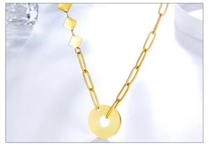 Detailed view of a gold stainless steel necklace with textured circular pendant on white base