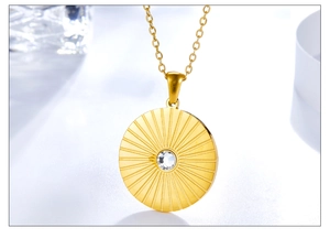 Macro shot of gold sunburst pendant necklace with a brilliant center zircon stone