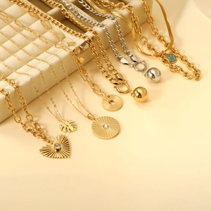 Minimalist stainless steel necklaces with heart pendants and leaf charms on display