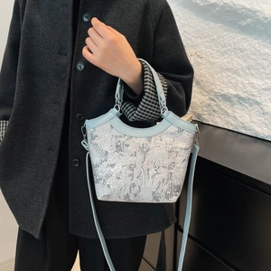 Elegant Chinese style embroidered bucket bag with light blue leather trim and top handle