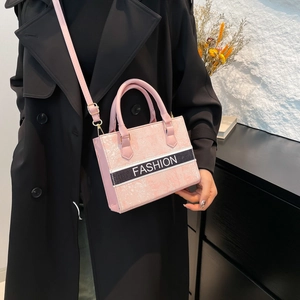 Pink rectangular tote bag with FASHION lettering and detachable shoulder strap