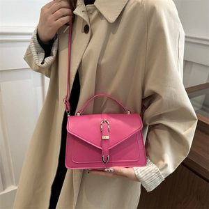 Fuchsia pink square flap crossbody bag with U-shaped metal buckle and top handle