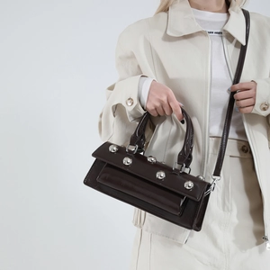 Deep brown baguette bag with large silver studs and top handle for women