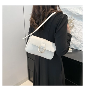Detail of white rectangular shoulder bag with golden U-shaped metal buckle and matte leather