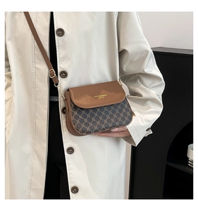 Detail of retro saddle bag with geometric jacquard pattern and adjustable brown strap