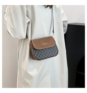 Detailed view of vintage monogram canvas texture and premium tan leather saddle bag flap