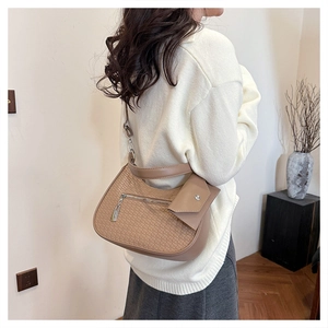 Detail der khakifarbenen gewebten Hobo-Tasche mit Textur und Metallreißverschluss am Riemen