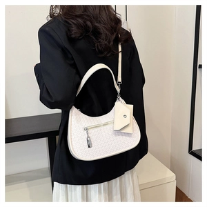 Detail der weißen geflochtenen Hobo-Tasche mit kleinem Geldbeutel und Reißverschluss